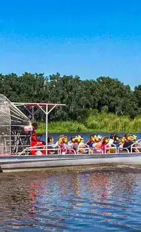Large airboat tour with excited passengers