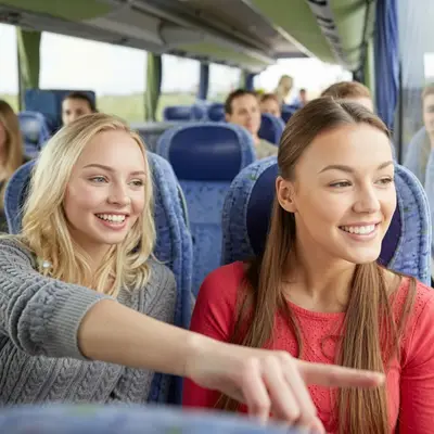 Smiling guests riding the shuttle bus from the French Quarter to the swamp tour dock